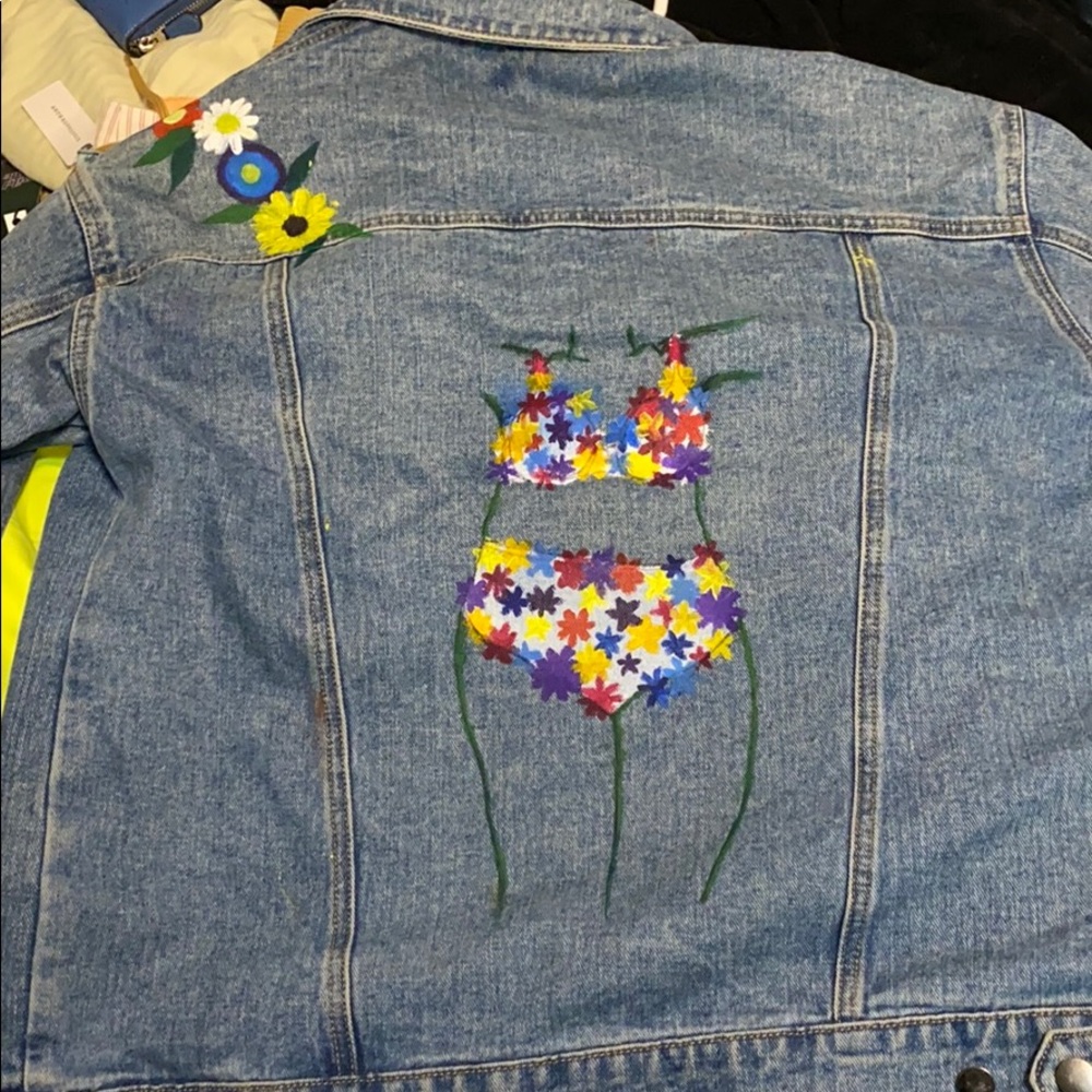 Jean jacket has a painting on the back